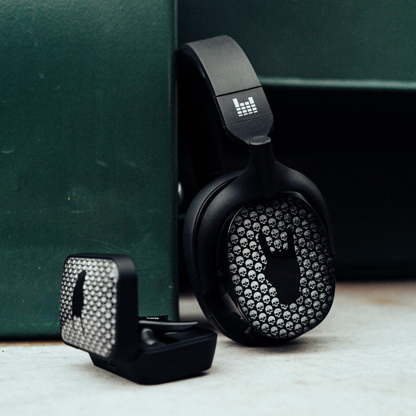 Black headphones with rhinestone embellishments on a green surface