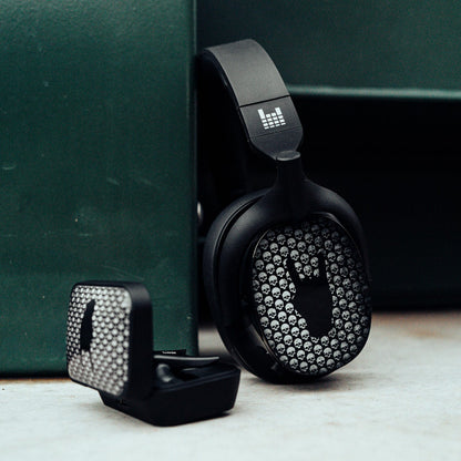 Black headphones with rhinestone embellishments on a green surface